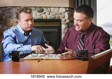 Stock Photography - Two men studying together. Fotosearch