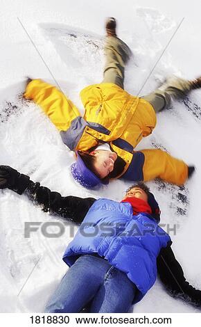 Two people making snow angels View Large Photo Image Stock Image - Two people making snow angels. Fotosearch