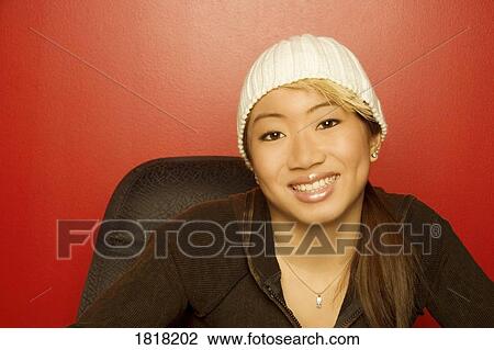 Stock Image - Woman wearing knit hat. Fotosearch
