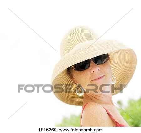Woman wearing straw hat View Large Photo Image Stock Photo - Woman wearing straw hat. Fotosearch