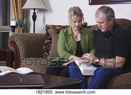 Stock Image - A couple praying. Fotosearch