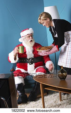 A woman serving pie to Santa View Large Photo Image Stock Image - A woman serving pie to Santa. Fotosearch