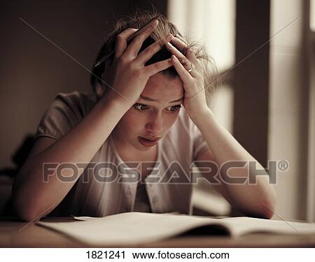 Stock Image - Anxious woman studying. Fotosearch