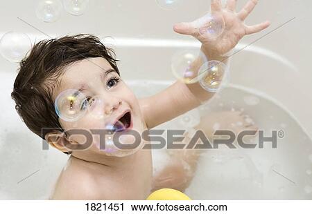 Stock Image - Baby in a bubble bath . Fotosearch