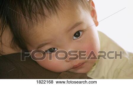 Baby on mother's shoulder View Large Photo Image Stock Photo - Baby on mother's shoulder. Fotosearch