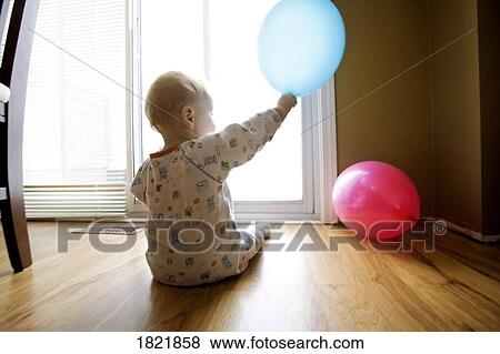 Baby playing with balloons View Large Photo Image Stock Photo - Baby playing with balloons. Fotosearch
