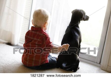 Stock Photo - Boy sitting with dog. Fotosearch