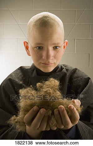 Stock Photo - Child holding his hair in his hands. Fotosearch