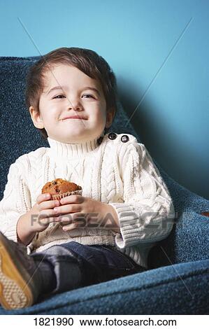 Stock Image - Child with muffin. Fotosearch