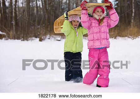Stock Photo - Children carrying toboggan . Fotosearch