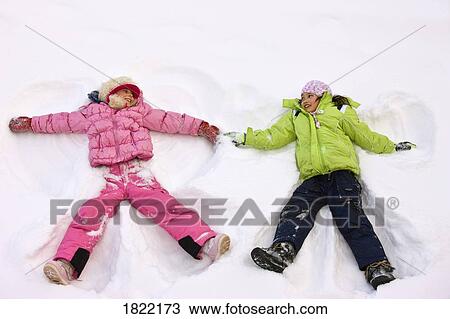 Stock Image - Children making snow angels . Fotosearch