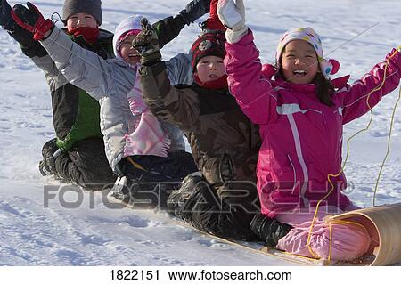 Stock Image - Children Tobogganing . Fotosearch