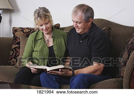 Picture - Couple reading together. Fotosearch