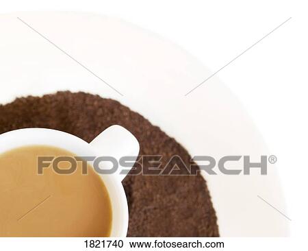 Stock Image - Cup of coffee and ground coffee. Fotosearch