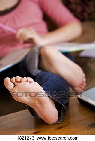 Stock Image - Feet on the coffee table. Fotosearch