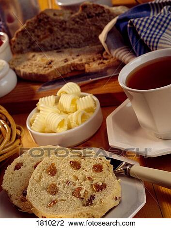 Stock Image - Fruit Scone, butter and tea. Fotosearch