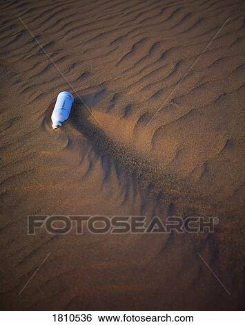 Stock Photograph - Garbage on a sandy beach. Fotosearch