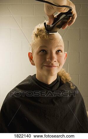 Stock Image - Getting hair buzzed off. Fotosearch