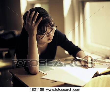 Girl working on homework View Large Photo Image Stock Photo - Girl working on homework. Fotosearch