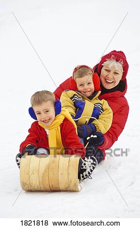Grandma and grandsons tobogganing View Large Photo Image Stock Photo - Grandma and grandsons tobogganing. Fotosearch