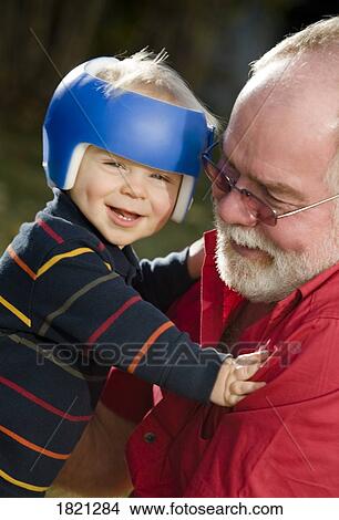 Picture - Grandpa holding grandson. Fotosearch