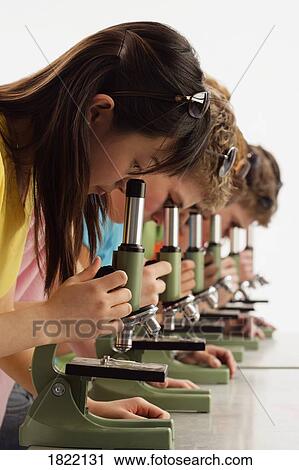 Group of teens looking into microscopes View Large Photo Image Stock Image - Group of teens looking into microscopes. Fotosearch