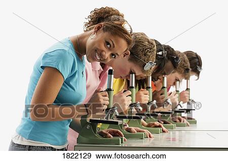 Group of teens looking into microscopes View Large Photo Image Stock Photo - Group of teens looking into microscopes. Fotosearch