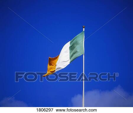Stock Photo - Irish flag against blue sky. Fotosearch