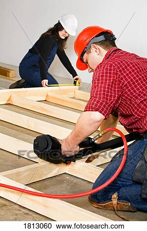 Male and female carpenters at work View Large Photo Image Stock Image - Male and female carpenters at work. Fotosearch