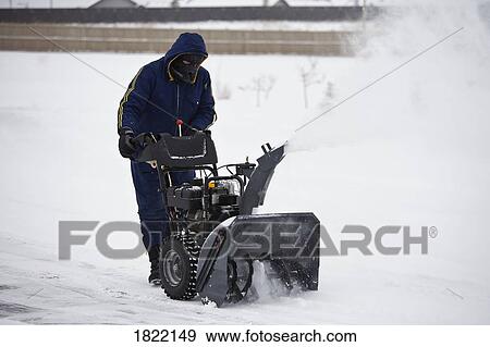 Stock Photo - Man operating a snowblower . Fotosearch
