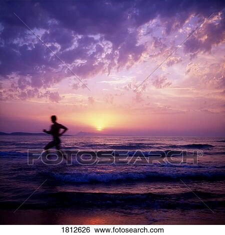 Stock Photograph - Man running in the water. Fotosearch
