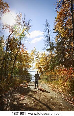 Man walking on trail View Large Photo Image Stock Image - Man walking on trail. Fotosearch