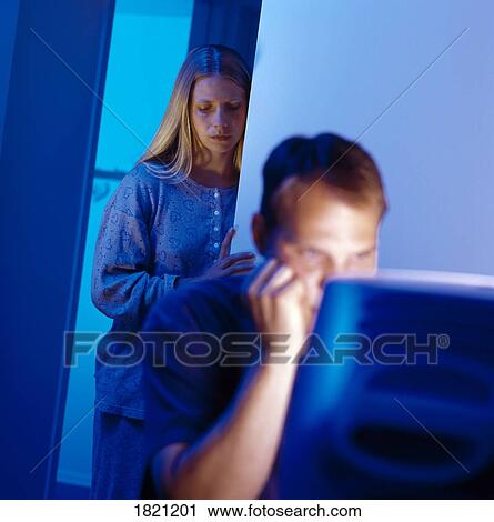 Man working at computer with sad woman in background View Large Photo Image Stock Image - Man working at computer with sad woman in background. Fotosearch