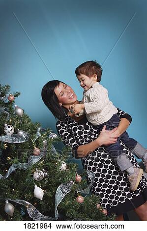 Picture - Mother and child decorating Christmas tree. Fotosearch