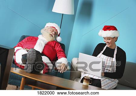 Stock Image - Mr. and Mrs. Claus at home. Fotosearch
