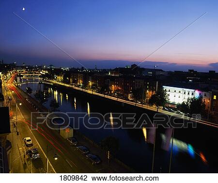Stock Image - River Liffey with a view of the quays and floodlight bridges, Dublin, Ireland. Fotosearch