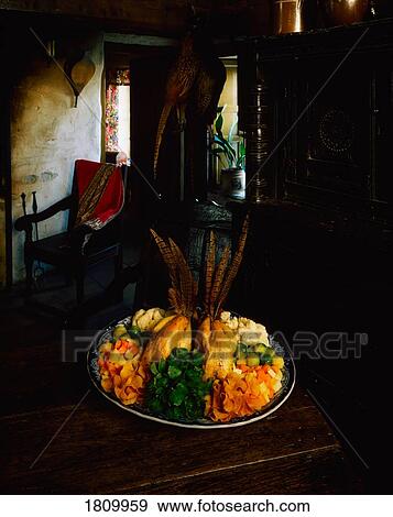 Stock Photo - Roast pheasant with vegetables. Fotosearch