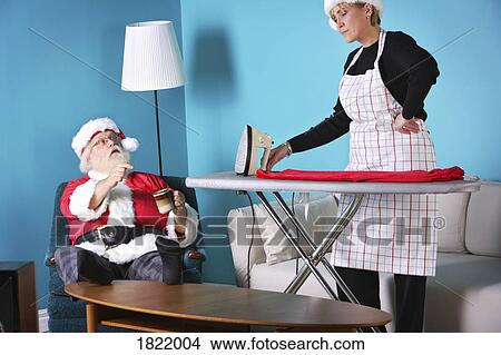 Picture - Santa and Mrs. Klaus at odds. Fotosearch