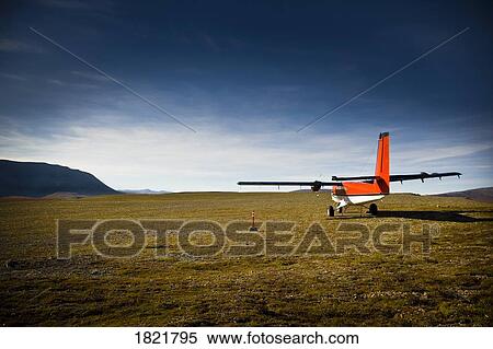 Stock Photography - Small aircraft in field. Fotosearch