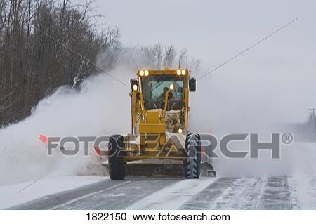 Stock Image - Snow plow clearing highway . Fotosearch