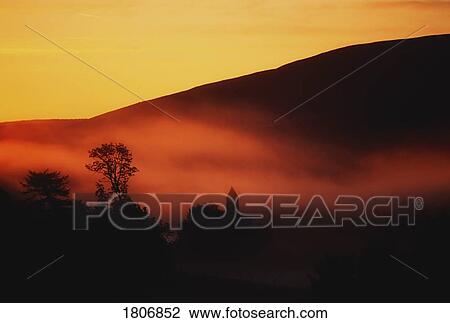 Stock Image - St. Kevin's Church at sunrise, Glendalough, Co Wicklow, Ireland. Fotosearch
