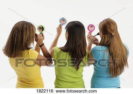 Three teen girls with compact mirrors View Large Photo Image Stock Photograph - Three teen girls with compact mirrors. Fotosearch