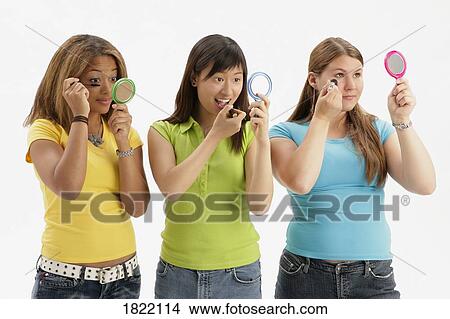 Picture - Three teens applying makeup. Fotosearch
