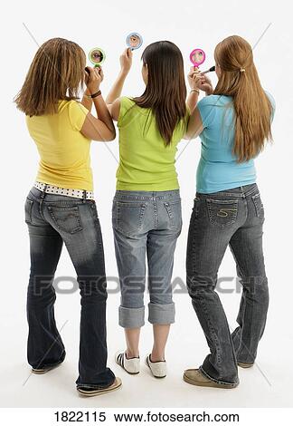 Stock Photography - Three teens applying makeup. Fotosearch