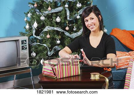 Stock Image - Woman wrapping a gift. Fotosearch