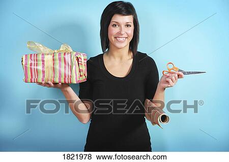 Stock Photo - Woman wrapping gift. Fotosearch