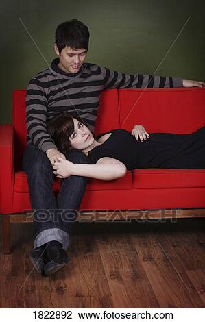 Stock Image - A couple on a couch. Fotosearch