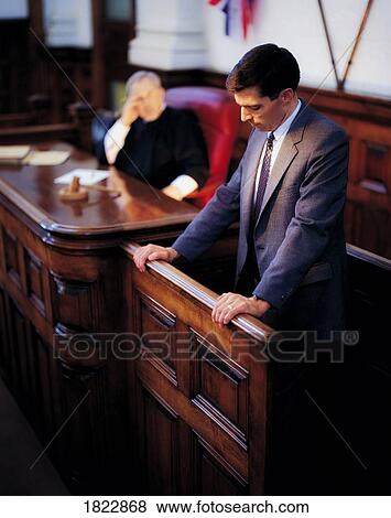 A man on the witness stand in a courtroom View Large Photo Image Stock Photo - A man on the witness stand in a courtroom. Fotosearch
