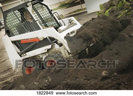 A man operating a skid loader View Large Photo Image Stock Photo - A man operating a skid loader. Fotosearch
