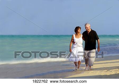 A senior couple walking along the beach View Large Photo Image Stock Photo - A senior couple walking along the beach. Fotosearch - Search Stock Photography, Print Pictures, Images, and Photo Clip Art